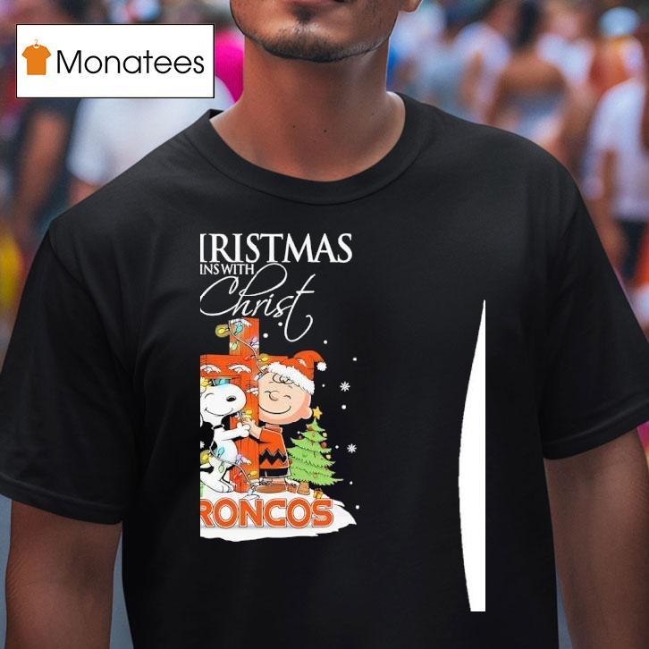 Denver Broncos Snoopy And Charlie Brown Holding Cross Christmas Begins With Chris T Shirt Denver Broncos Snoopy And Charlie Brown Holding Cross Christmas Begins With Chris T Shirt