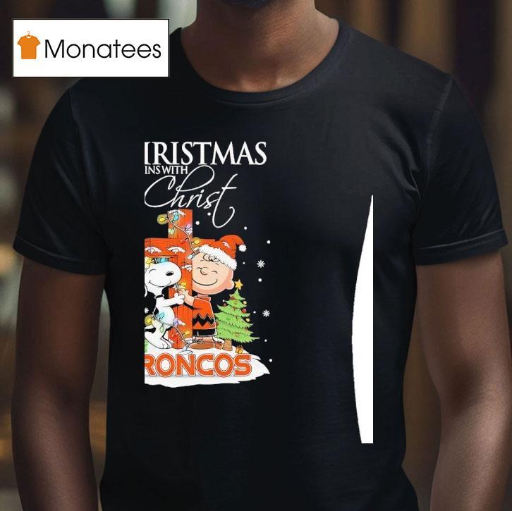 Denver Broncos Snoopy And Charlie Brown Holding Cross Christmas Begins With Chris T Shirt Denver Broncos Snoopy And Charlie Brown Holding Cross Christmas Begins With Chris T Shirt